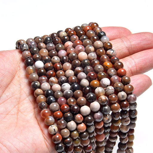 This is a Dakota Stones 6mm African Petrified Wood Agate Large Gemstone strand with round beads in 8 inch strand.
