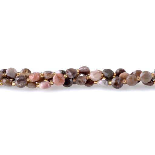 This is a Dakota Stones 8mm African Petrified Wood Agate Cut Gemstone strand with coin star beads in 15-16 inch strand.