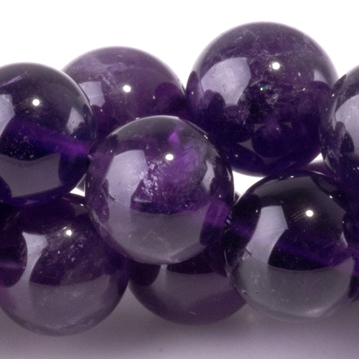 This is a Dakota Stones 10mm Amethyst Gemstone strand with A grade round beads in 15-16 inch strand.