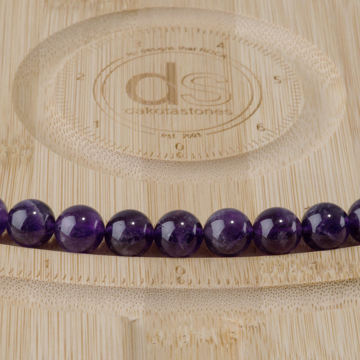 This is a Dakota Stones 10mm Amethyst Gemstone strand with A grade round beads in 15-16 inch strand.