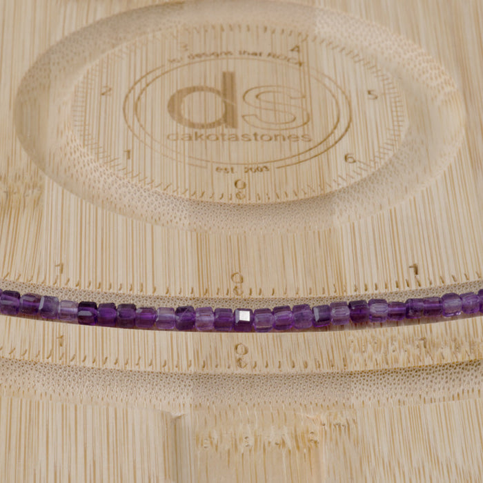 This is a Dakota Stones 3mm Amethyst Table Cut Gemstone strand with A grade cube beads in 15-16 inch strand.