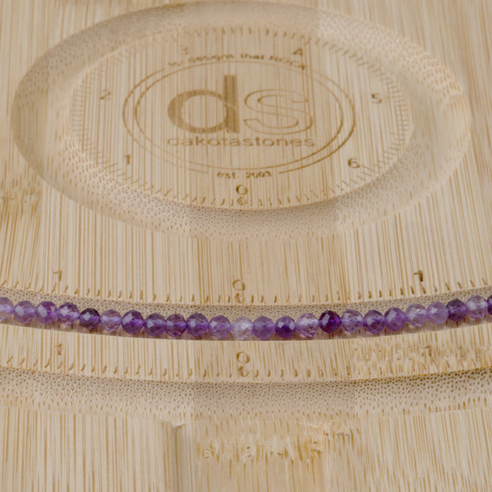 This is a Dakota Stones 3mm Amethyst Gemstone strand with A grade faceted round beads in 15-16 inch strand.