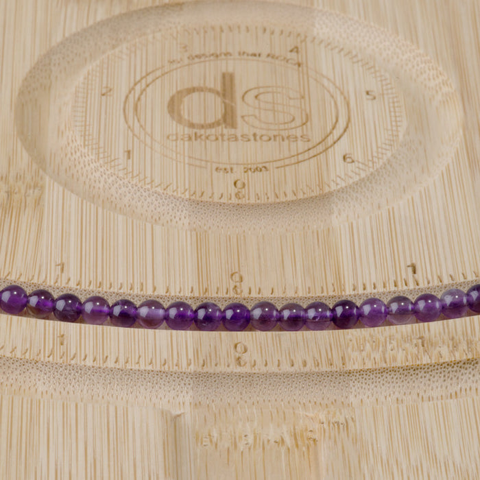 This is a Dakota Stones 4mm Amethyst Gemstone strand with A grade round beads in 15-16 inch strand.