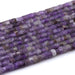This is a Dakota Stones 6mm Amethyst Large Hole Gemstone strand with faceted hexagon beads in 8 inch strand.