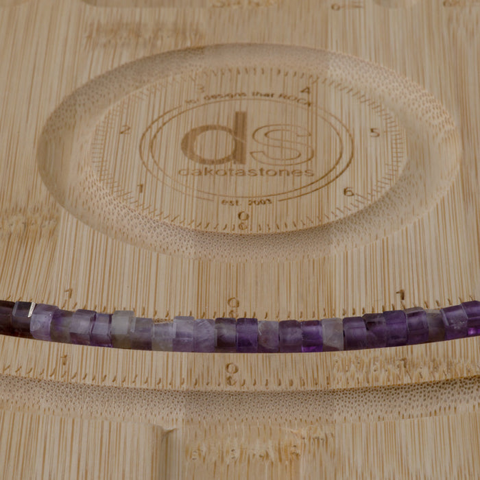 This is a Dakota Stones 6mm Amethyst Large Hole Gemstone strand with faceted hexagon beads in 8 inch strand.