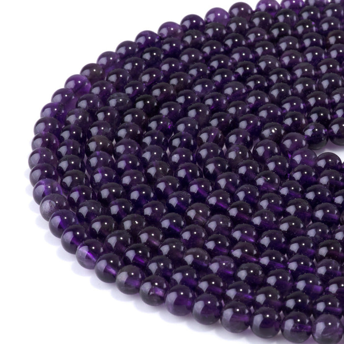 This is a Dakota Stones 6mm Amethyst Gemstone strand with A grade round beads in 15-16 inch strand.