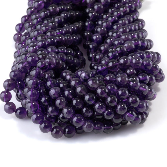 This is a Dakota Stones 6mm Amethyst Gemstone strand with A grade round beads in 15-16 inch strand.