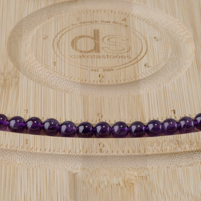This is a Dakota Stones 6mm Amethyst Gemstone strand with A grade round beads in 15-16 inch strand.