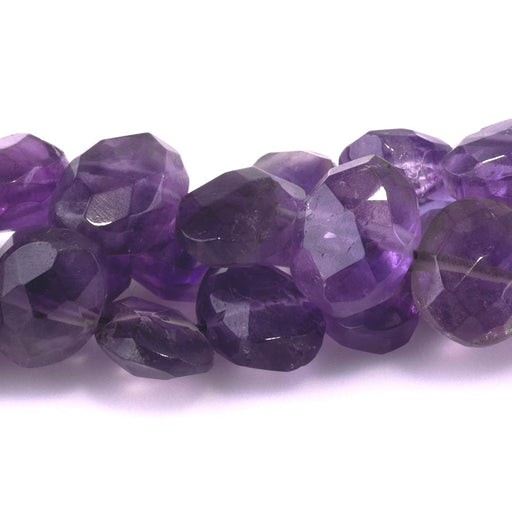 This is a Dakota Stones 7x10-8x14mm Amethyst Gemstone strand with faceted irregular oval beads in 10 inch strand.