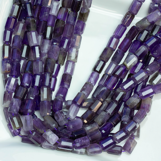 This is a Dakota Stones 7x10mm Amethyst Tube Gemstone strand with faceted beads in 15-16 inch strand.