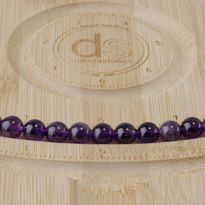 This is a Dakota Stones 8mm Amethyst Gemstone strand with A grade round beads in 15-16 inch strand.
