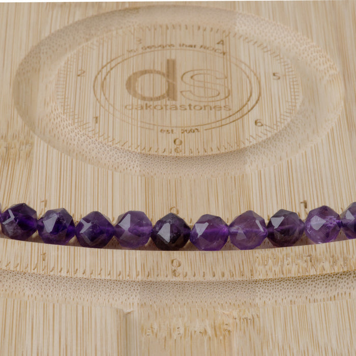 This is a Dakota Stones 8mm Amethyst Gemstone strand with A grade double heart faceted round beads in 15-16 inch strand.