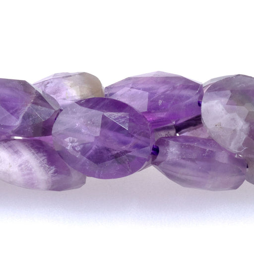 This is a Dakota Stones 8x10mm Amethyst Triangle Cut Puff Gemstone strand with faceted oval beads in 15-16 inch strand.