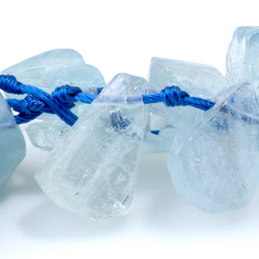 This is a Dakota Stones 9x13-12x16mm Aquamarine Top Drill Flat Gemstone strand with irregular drop beads in 15-16 inch strand.