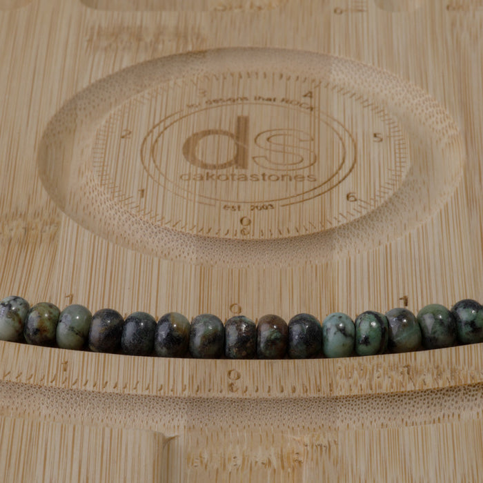 This is a Dakota Stones 5x8mm African Turquoise Large Hole Gemstone strand with rondelle beads in 8 inch strand.