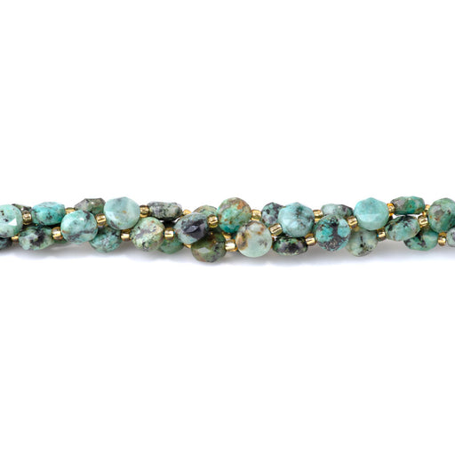 This is a Dakota Stones 8mm African Turquoise Cut Gemstone strand with A grade coin star beads in 15-16 inch strand.
