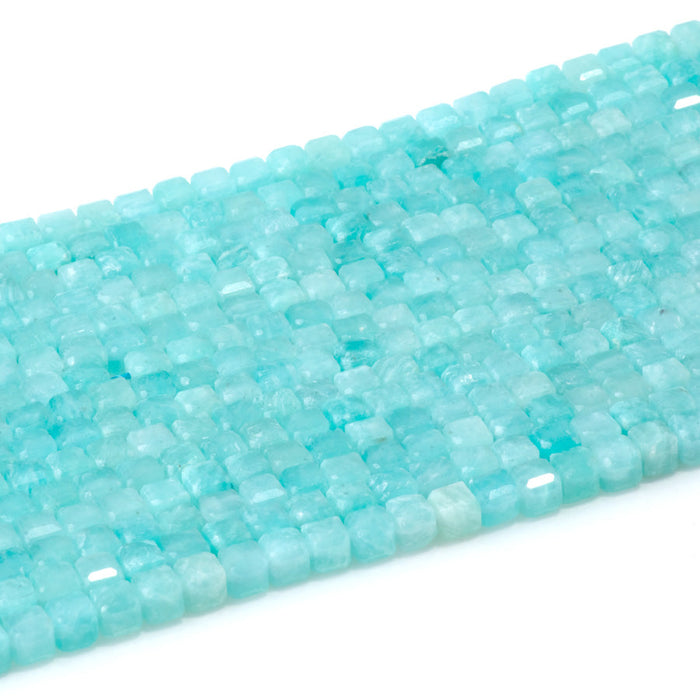 This is a Dakota Stones 4mm Brazilian Amazonite Gemstone strand with natural A grade table-cut cube beads in 15-16 inch strand.