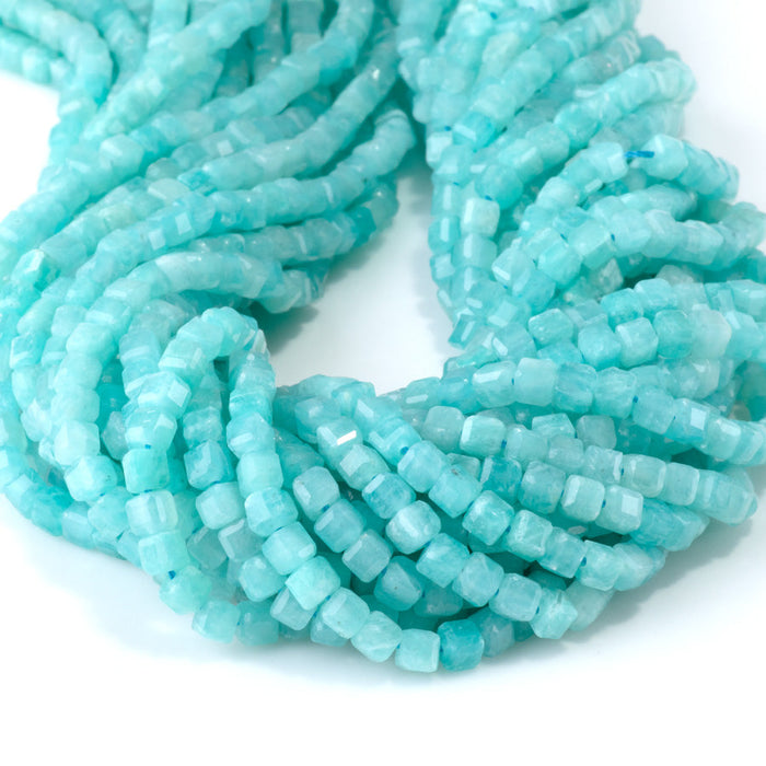 This is a Dakota Stones 4mm Brazilian Amazonite Gemstone strand with natural A grade table-cut cube beads in 15-16 inch strand.