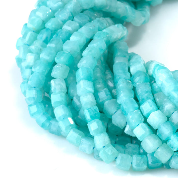 This is a Dakota Stones 4mm Brazilian Amazonite Gemstone strand with natural A grade table-cut cube beads in 15-16 inch strand.