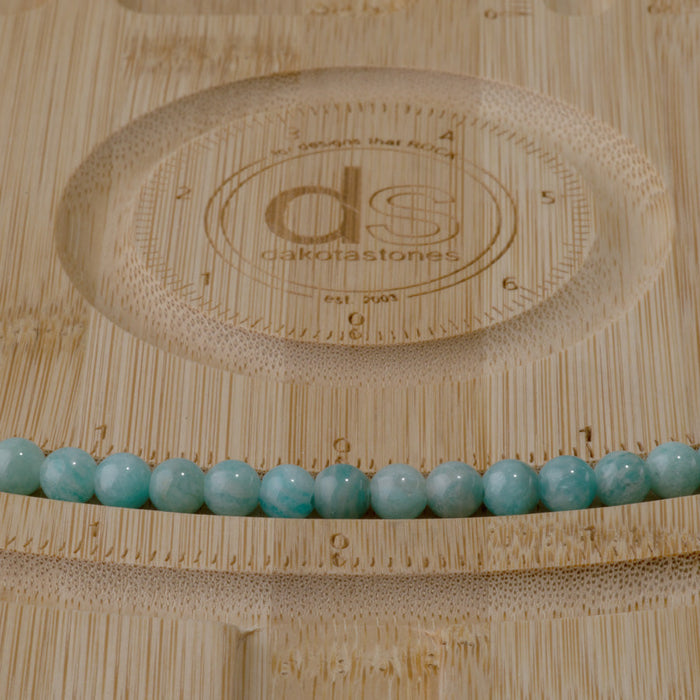 This is a Dakota Stones 6mm Brazilian Amazonite Large Hole Gemstone strand with round beads in 8 inch strand.