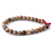 This is a Dakota Stones 8mm Birds Eye Rhyolite Large Hole Gemstone strand with round beads in 8 inch strand.