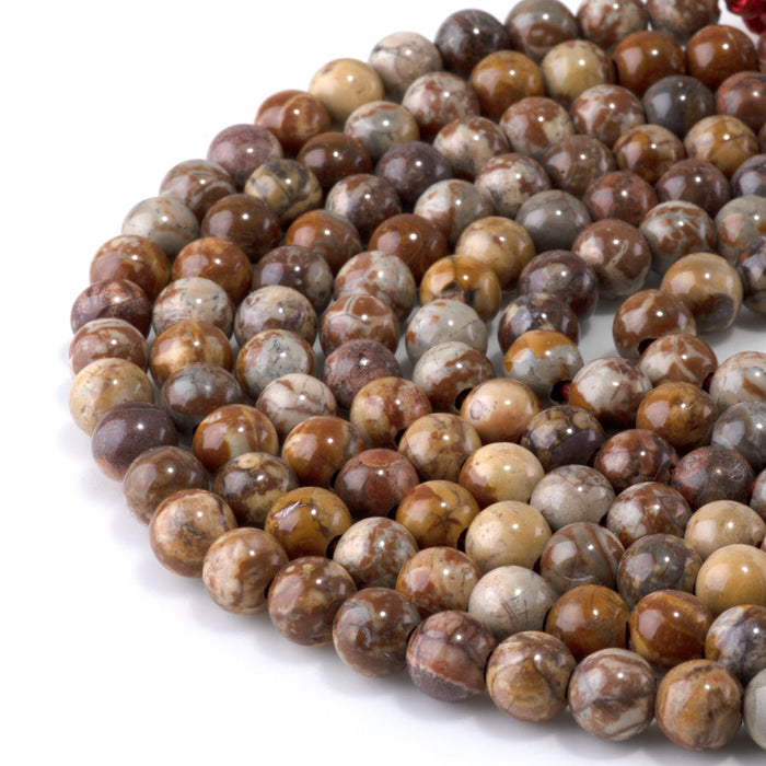 This is a Dakota Stones 8mm Birds Eye Rhyolite Large Hole Gemstone strand with round beads in 8 inch strand.