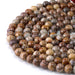 This is a Dakota Stones 8mm Birds Eye Rhyolite Large Hole Gemstone strand with round beads in 8 inch strand.
