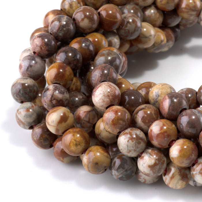 This is a Dakota Stones 8mm Birds Eye Rhyolite Large Hole Gemstone strand with round beads in 8 inch strand.