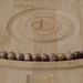 This is a Dakota Stones 8mm Birds Eye Rhyolite Large Hole Gemstone strand with round beads in 8 inch strand.