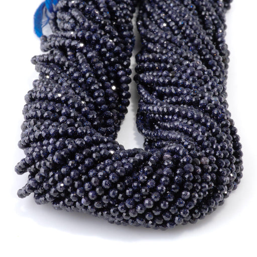 This is a Dakota Stones 3mm Special Price Blue Goldstone Gemstone strand with faceted round beads in 15 inch strand.