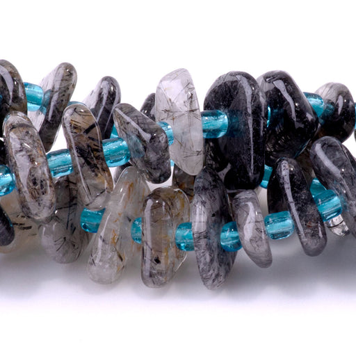 This is a Dakota Stones 5x8mm Black Rutilated Quartz Gemstone strand with chip beads in 15-16 inch strand.