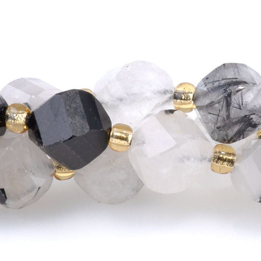 This is a Dakota Stones 7x8mm Black Rutilated Quartz Swirl Gemstone strand with faceted oval beads in 15-16 inch strand.