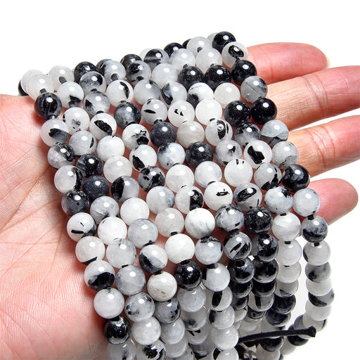 This is a Dakota Stones 8mm Black Rutilated Quartz Large Hole Gemstone strand with round beads in 8 inch strand.