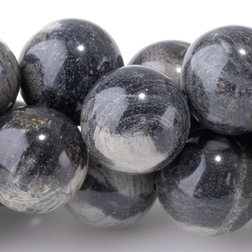 This is a Dakota Stones 12mm Black Silver Leaf Jasper Gemstone strand with round beads in 15-16 inch strand.