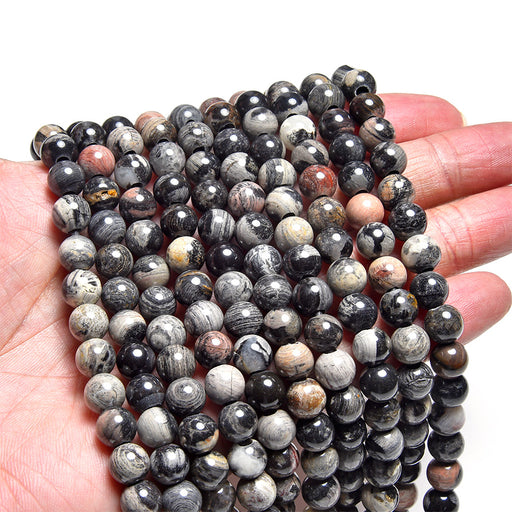 This is a Dakota Stones 8mm Black Silver Leaf Jasper Large Gemstone strand with round beads in 8 inch strand.