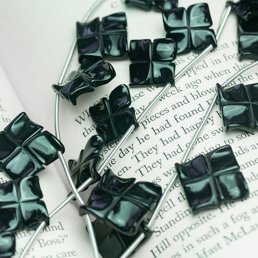 This is a Dakota Stones 15mm Black Spinel Pinwheel Gemstone strand of round beads in 8 inch strand.