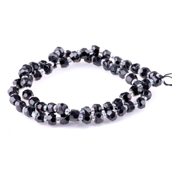This is a Dakota Stones 4x6mm Black Spinel Irr Gemstone strand with faceted rondelle beads in 15-16 inch strand.