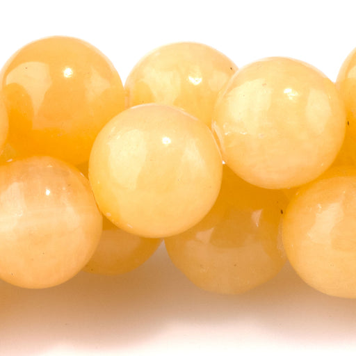 This is a Dakota Stones 10mm Yellow Calcite Gemstone strand with A grade round beads in 15-16 inch strand.