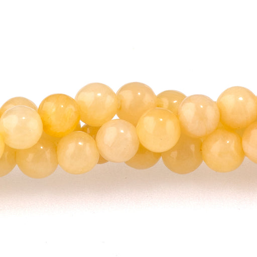 This is a Dakota Stones 4mm Yellow Calcite Gemstone strand with A grade round beads in 15-16 inch strand.