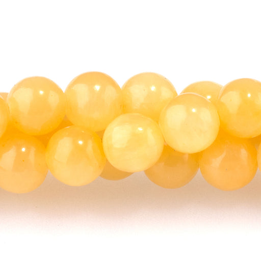 This is a Dakota Stones 6mm Yellow Calcite Gemstone strand with A grade round beads in 15-16 inch strand.