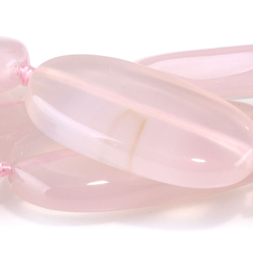 This is a Dakota Stones 13x22-30mm Pink Chalcedony Gemstone strand with oval beads in 15-16 inch strand.