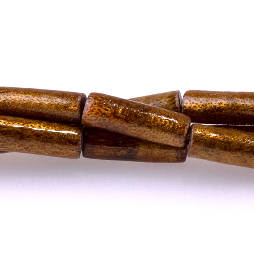 This is a Dakota Stones 5x15mm Coral Tube Golden Gemstone strand of round beads in 15-16 inch strand.