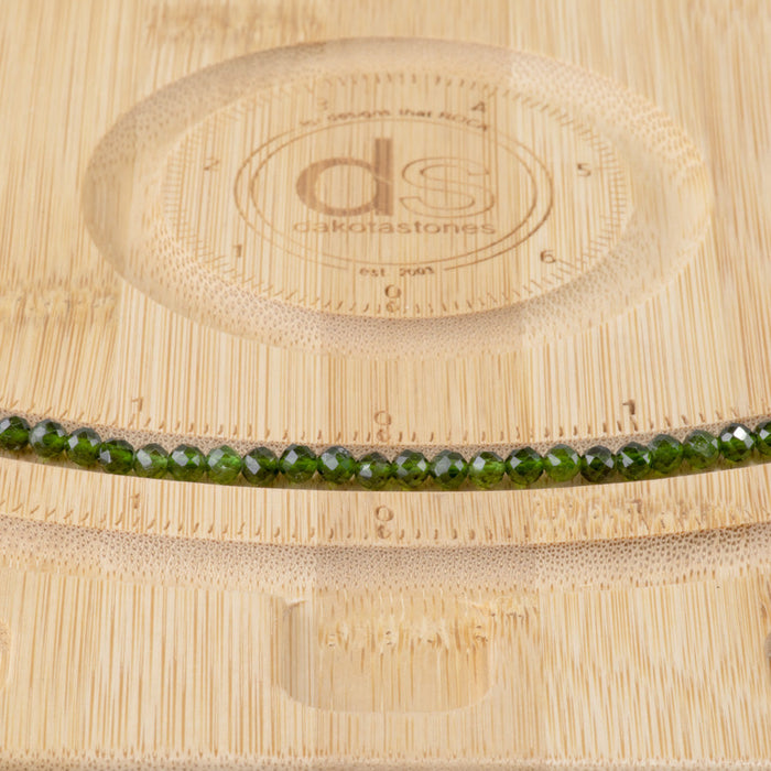 This is a Dakota Stones 4mm Diopside Gemstone strand with AA grade faceted round beads in 15-16 inch strand.