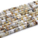 This is a Dakota Stones 6mm Dendritic Opal Large Hole Gemstone strand with faceted hexagon beads in 8 inch strand.