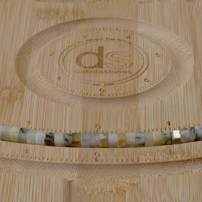 This is a Dakota Stones 6mm Dendritic Opal Large Hole Gemstone strand with faceted hexagon beads in 8 inch strand.