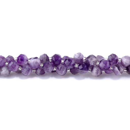 This is a Dakota Stones Dog Teeth Amethyst 7x8mmfaceted Gemstone strand with nugget beads in 15-16 inch strand.