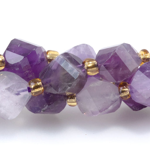 This is a Dakota Stones 7x8mm Dog Teeth Amethyst Swirl Gemstone strand with faceted oval beads in 15-16 inch strand.