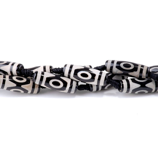 This is a Dakota Stones 10x30mm DZI Agate Three Eye Black Gemstone strand with barrel beads in 15-16 inch strand.