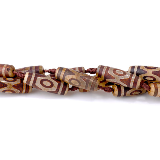 This is a Dakota Stones 10x30mm DZI Agate Three Eye Brown Gemstone strand with barrel beads in 15-16 inch strand.