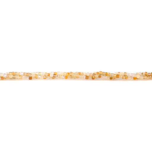 This is a Dakota Stones 2-5mm Austrailian Ethiopian Opal Light Yellow Gemstone strand with faceted cube beads in 15-16 inch strand.